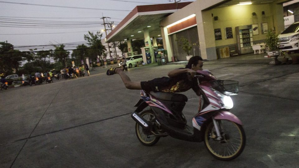 A teen street racer shows off a motorcycle trick for his friends. File photo: Alexander Hotz/ Coconuts Media