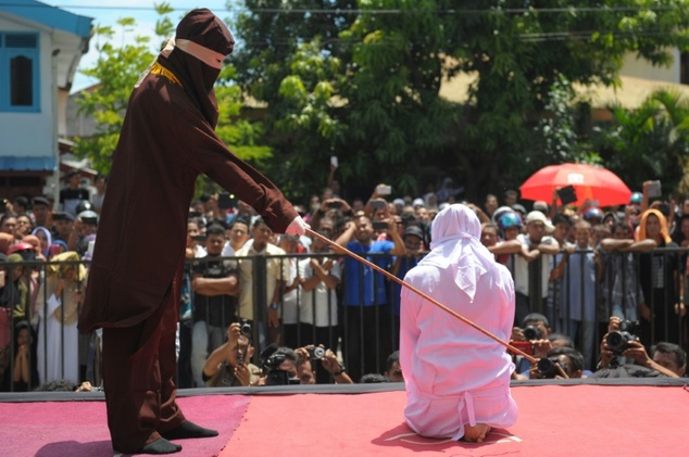 A woman is caned in Indonesia’s Aceh province in this file photo from 2016. Two women in Malaysia’s Terengganu state suffered a similar fate on Monday, Sept. 3, after a sharia court found them guilty of engaging in lesbian sex. AFP FILE PHOTO