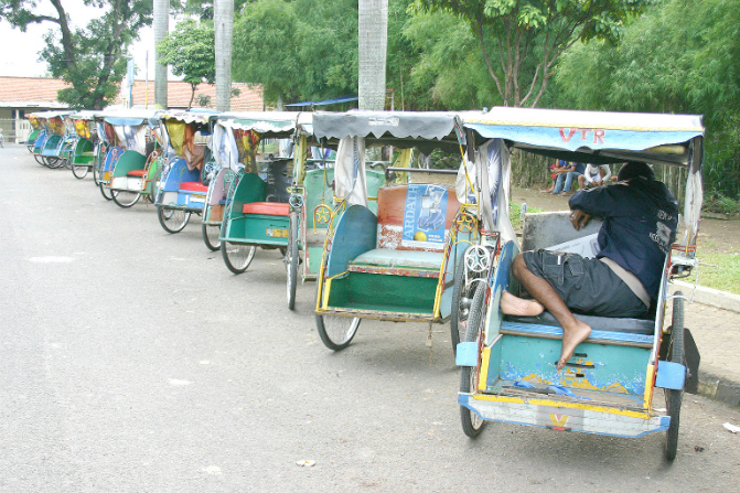 Traditional becaks lined up on a street in Bogor, West Java.