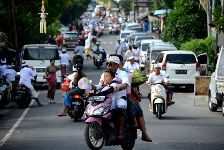 Balinese people prepare to pray at a temple to celebrate Galungan day in Jimbaran, on Indonesia’s resort island of Bali on February 10, 2016. Galungan Day is a holiday celebrated by Balinese as a sign of victory of good against evil. Photo: Sonny Tumbelaka/AFP
