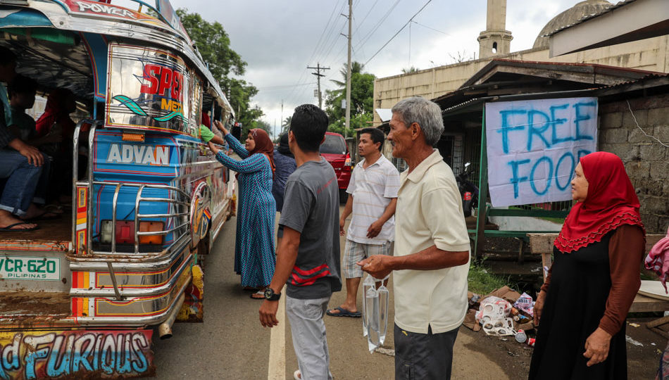 Marawi residents receive food from members of the Riga family. PHOTO: ABS-CBN News/Jonathan Cellona