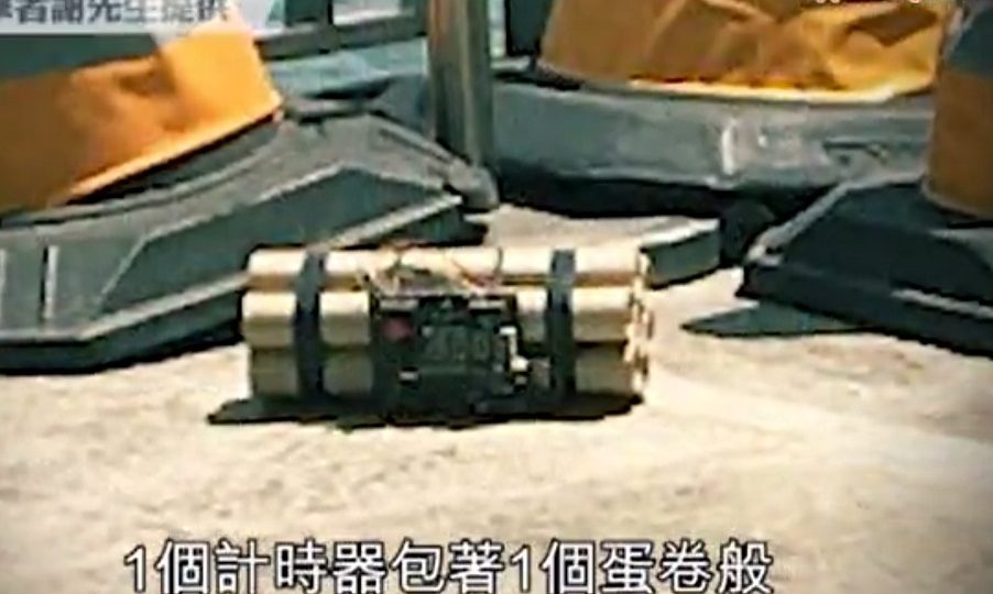 The bomb, which was made up of seven paper tubes bundled together with electrical cables and an alarm clock, was found by a security guard outside the Ocean Terminal section of Harbour City. Screenshot: Apple Daily