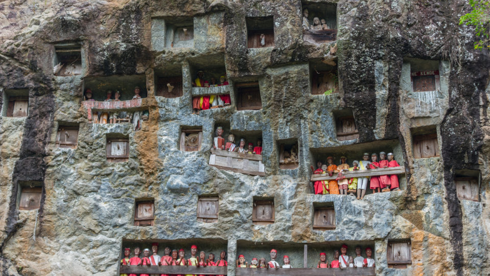 Lemo (Tana Toraja, South Sulawesi, Indonesia), famous burial site with coffins placed in caves carved into the rock, guarded by balconies of dressed wooden statues, images of the dead persons (called tau tau in local language). Photo: iStock