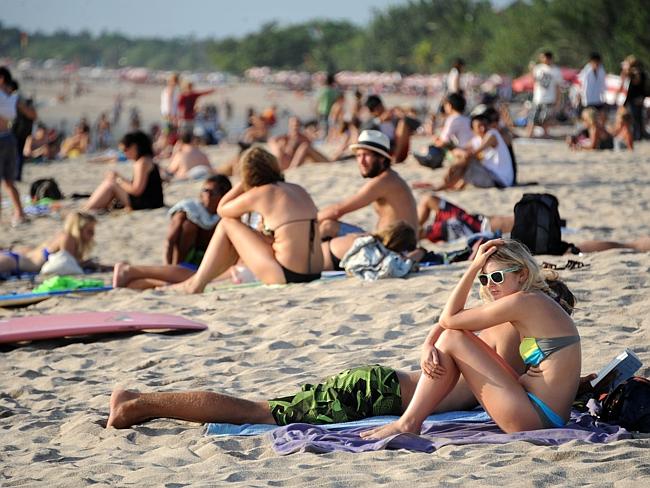 File photo of tourists on Kuta Beach, before the pandemic. Photo: Sonny Tumbelaka/AFP