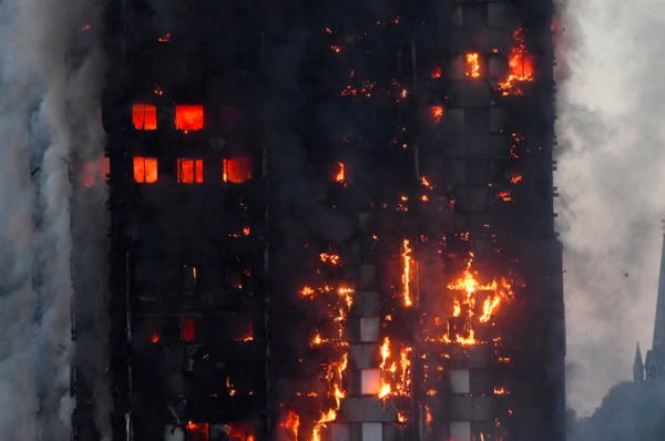 Flames and smoke engulf a tower block, in north Kensington, West London, Britain on Wednesday. PHOTO: Toby Melville, Reuters