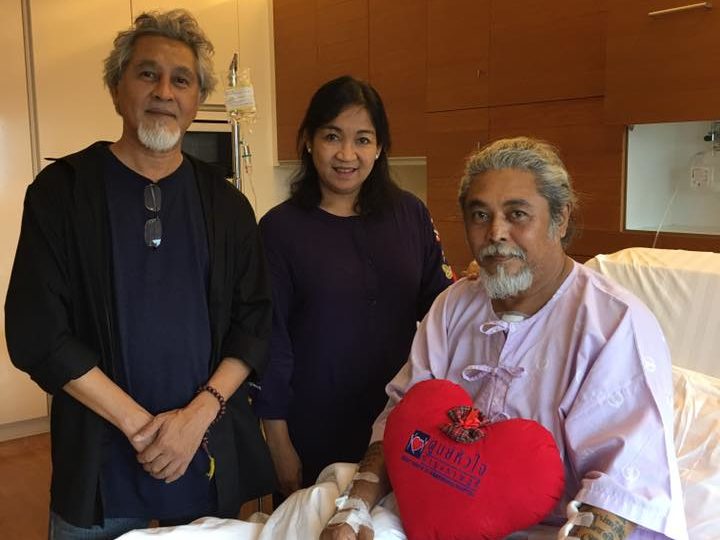 Kyaw Thu with his wife and brother in his hospital room at Bumrungrad. Photo: Facebook / Myint Myint Khin Pe