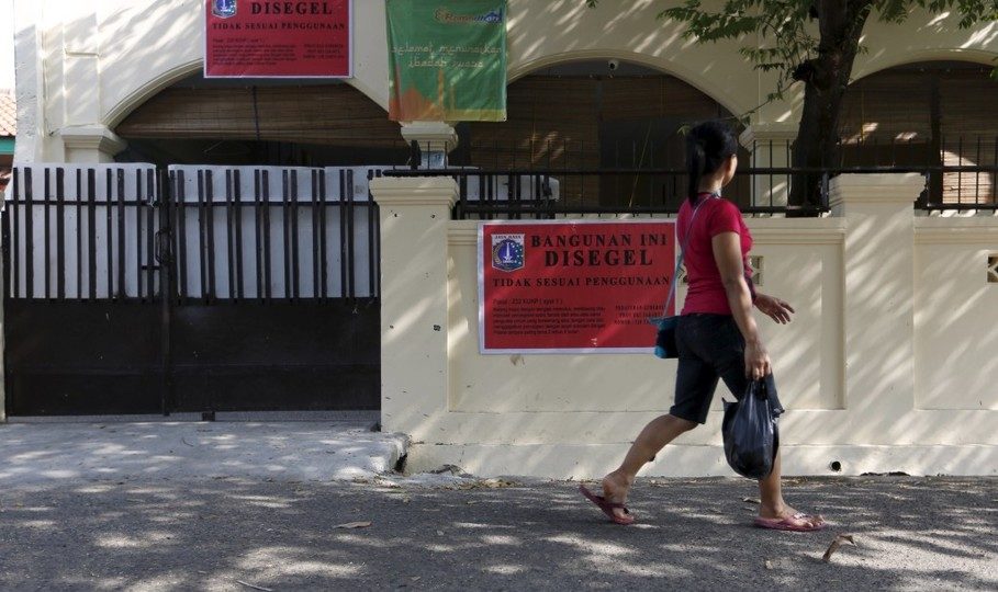 A woman walks past a mosque belonging to Ahmadiyah, an Indonesian minority Islamic community, which was closed this week by government authorities in South Jakarta, Indonesia, July 9, 2015. Photo: REUTERS/Nyimas Laula