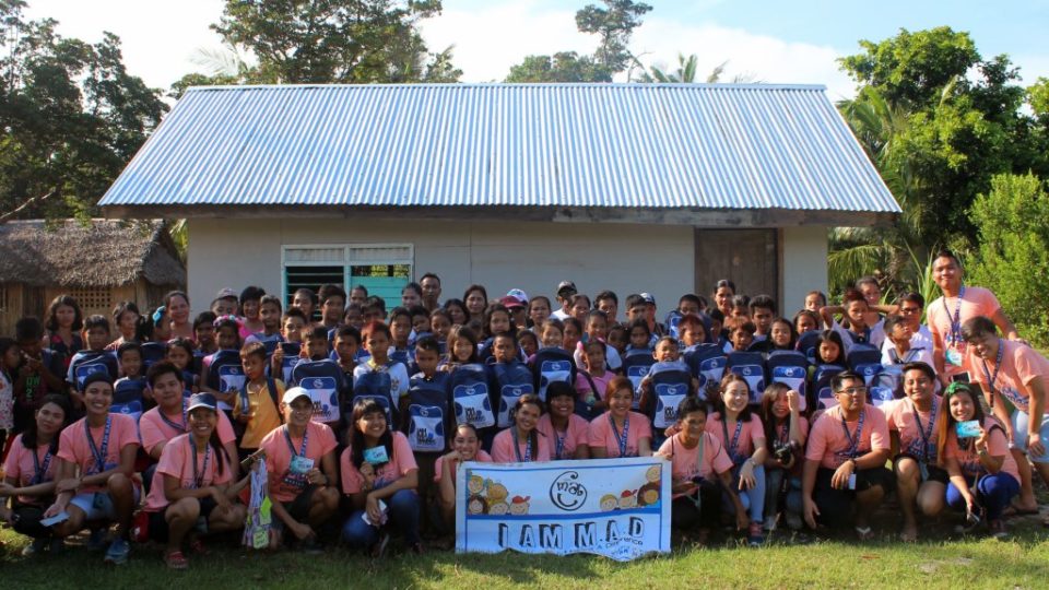 Millenial volunteers together with the beneficiaries and their parents pose for a souvenir photo. Firing up the spirit of volunteerism while traveling. I am M.A.D. (Making A Difference) conquered the town of Magdiwang, Sibuyan Island, Romblon for its 32nd MAD Camp area at Tomas and Maria Maglaya Memorial School.