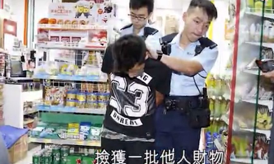 The second thief, who was found in possession of stolen wallets and ID cards, as well as the two stolen cakes. Screenshot: Apple Daily