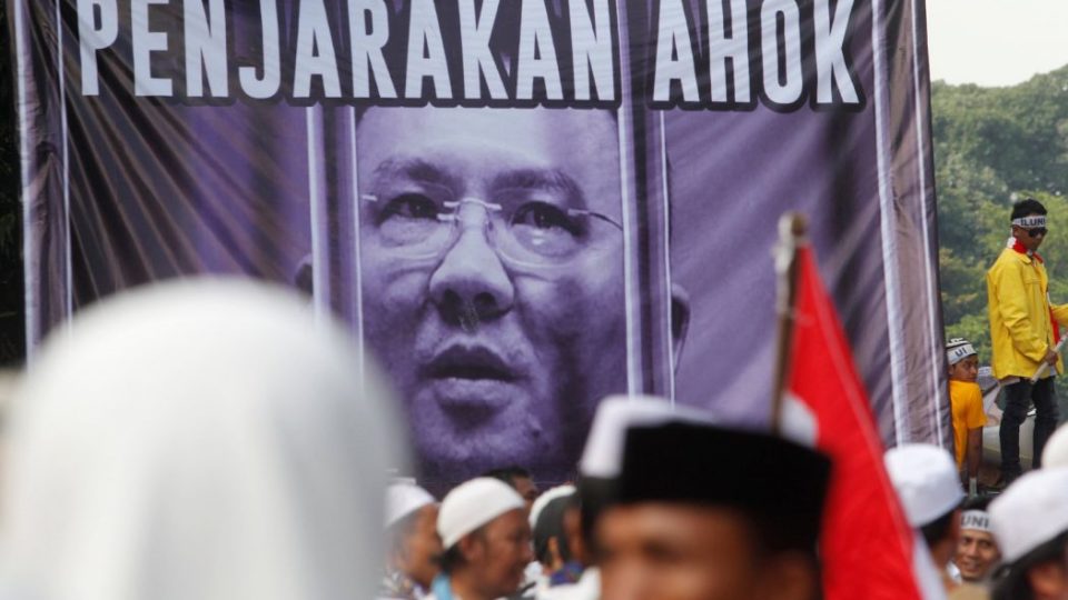 Indonesian protesters chant in front of a poster of Basuki Tjahaja Purnama, known by his nickname Ahok, as they march down the capital city’s main street after a demonstration at Jakarta’s National Monument Park on December 2, 2016. More than 100,000 Indonesian Muslims protested on December 2, 2016 against Jakarta’s Christian governor, the second major demonstration in a matter of weeks as conservative groups push for his arrest on accusations of insulting Islam. GOH CHAI HIN / AFP