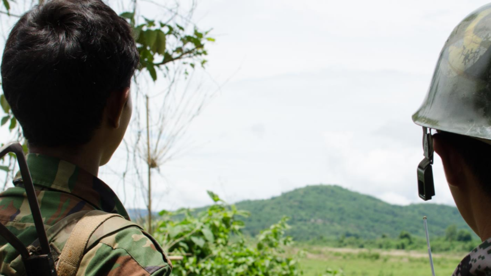 Two soldiers from the Kachin Independence Army  look out at the hills near Laiza, in an area of Kachin State controlled by the KIA, June 2013. Photo: Amnesty International / Daniel Quinlan