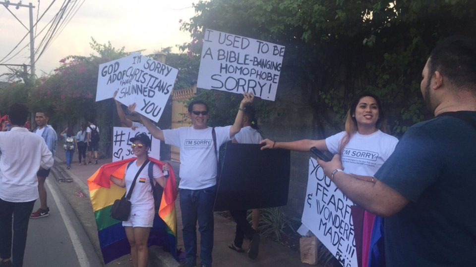 Pastor Val Palmiñano and members of the Freedom In Christ Ministries hold signs of encouragement and love at the 23rd Pride March on June 24, 2017. PHOTO: Twitter/Jessica Bartolome for GMA News