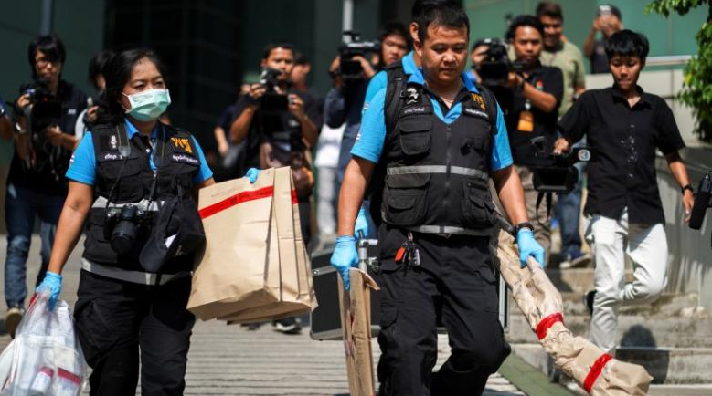 Officers collect forensic evidence last month. Photo: Reuters