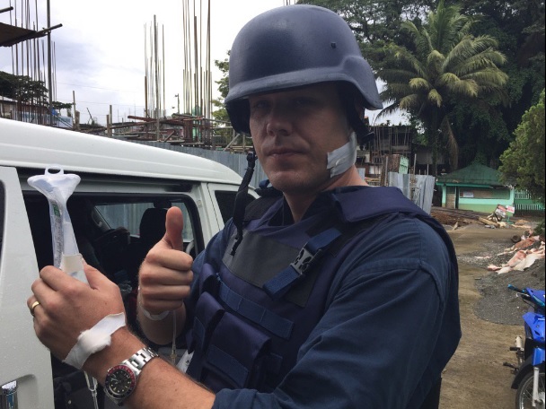 ABC journalist Adam Harvey survives being hit by a stray bullet