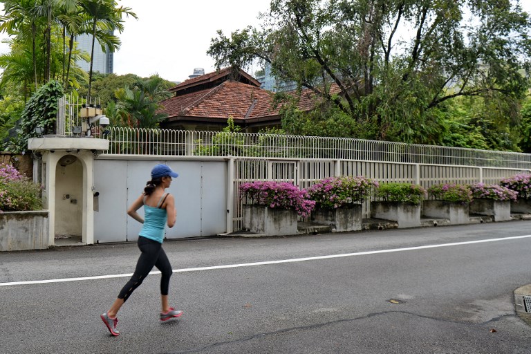 A woman jogs past the house of Singapore’s late prime minister Lee Kuan Yew on 38 Oxley Road. Photo: Roslan Rahman / AFP