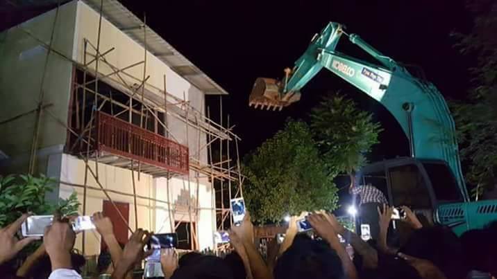 Authorities brought in heavy machinery to demolish the building late last night. Photo: Facebook / Lwin Oo