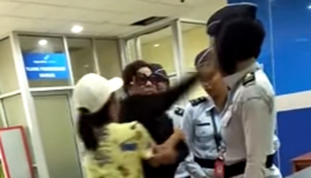 Screengrab from the viral video in which the wife of an Indonesian police general slapped an airport security officer after she refused to take off her watch for X-ray.