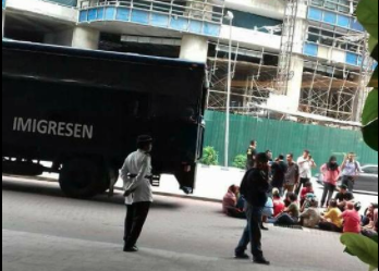 Undocumented workers waiting to be taken for processing 