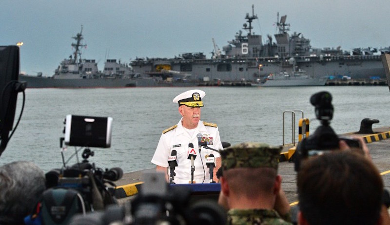 Admiral Scott Swift, commander of the U.S. Pacific Fleet, speaks to reporters during a press conference, as the guided-missile destroyer USS John S. McCain is seen in the background, at Changi naval base in Singapore on August 22, 2017.
Divers searching for 10 missing sailors on a US destroyer that collided with a tanker off Singapore have found human remains, the commander of the US Pacific Fleet said on August 22. Photo: Roslan Rahman/AFP 