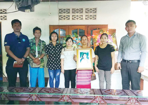 The victim’s family holds up a photo of the 17-year-old. Photo: AAC