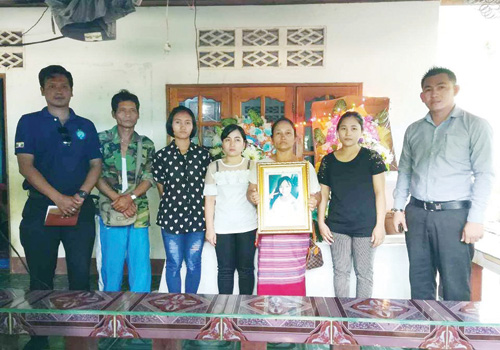 Relatives hold a photo of Nyo Nyo Aye. Photo: AAC