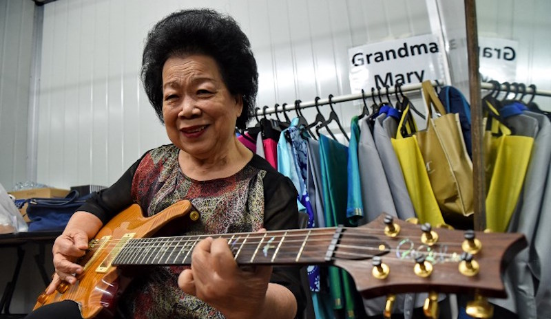 Grandma Mary, posing with her electric guitar during a rehearsal in Singapore. Photo: Roslan Rahman/AFP 