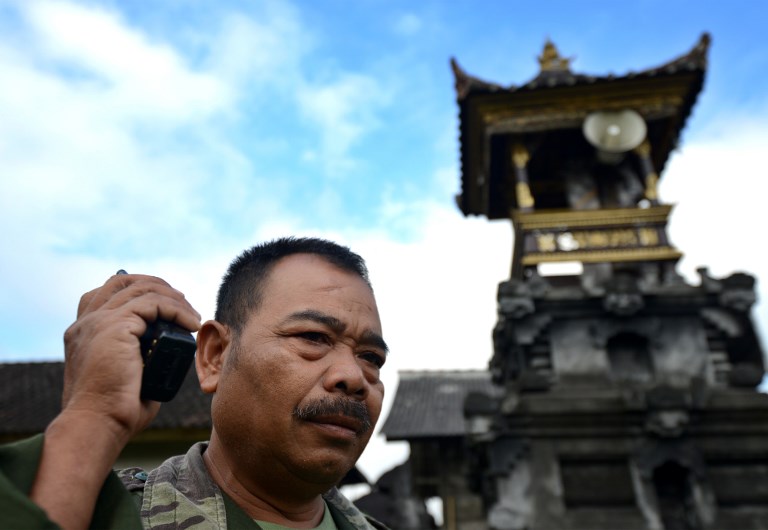 A man monitors during the raised alert levels for the volcano on Mount Agung at Rendang subdistrict in Klungkung regency on Bali island on September 21, 2017.
Authorities have raised alert levels for a volcano on the Indonesian resort island of Bali after hundreds of small tremors stoked fears it could erupt for the first time in more than 50 years. Photo: Sonny Tumbelaka/AFP