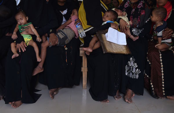 Rohingya Muslim refugees wait with their children for a consultation at a clinic run by the International Organization for Migration (IOM) in Leda refugee camp near the Bangladeshi town of Teknaf on September 18, 2017. / AFP / DOMINIQUE FAGET