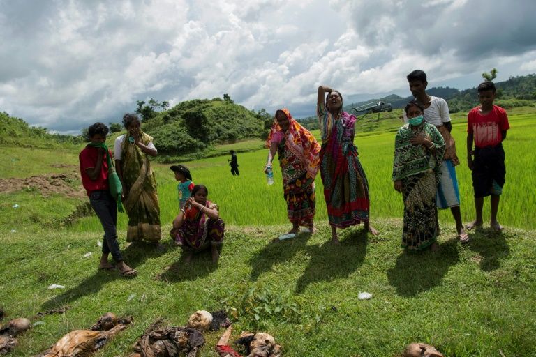 Hindu villagers cry near the dead bodies of their family members in Yebawkya village, Maungdaw, on September 27, 2017. Photo: STR / AFP