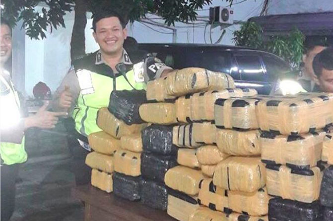 Officers of the Jakarta Traffic Police posing next to their catch. Photo: Instagram/@tmcpoldametro