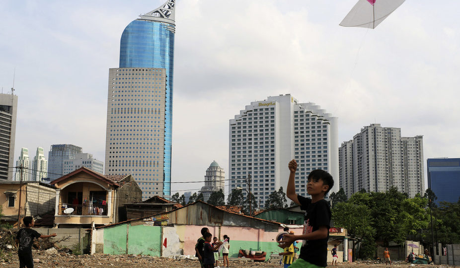 Children fly their kites in a demolished neighborhood in Jakarta. Studies show inequality and injustice are highly toxic to our health and wellbeing. Photo: Beawiharta/Reuters