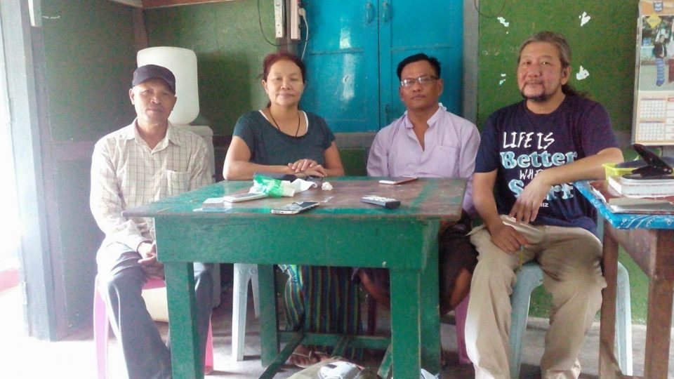 Ko Min Htay, second from the right, sits with friends at the Banmaw police station hours before a judge decides to set him free after nine months in prison. Photo: Facebook / Thet Hmu