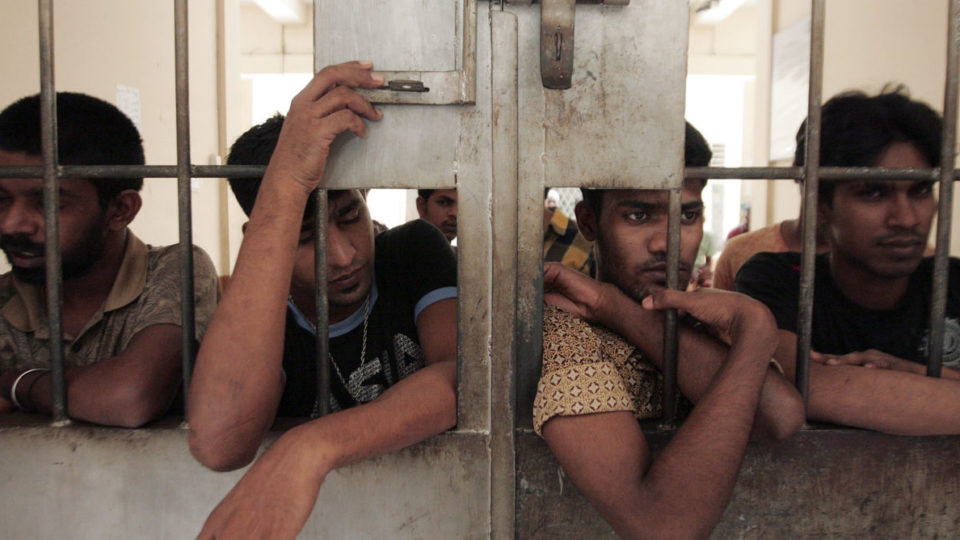 Illegal migrants from Myanmar stand at the gate of an immigration detention centre in Medan in Indonesia’s North Sumatra province April 5, 2013. Eight illegal migrants were killed after a brawl between Buddhist and Muslim asylum seekers from Myanmar, a police official said on Friday. Photo: REUTERS/Roni Bintang 