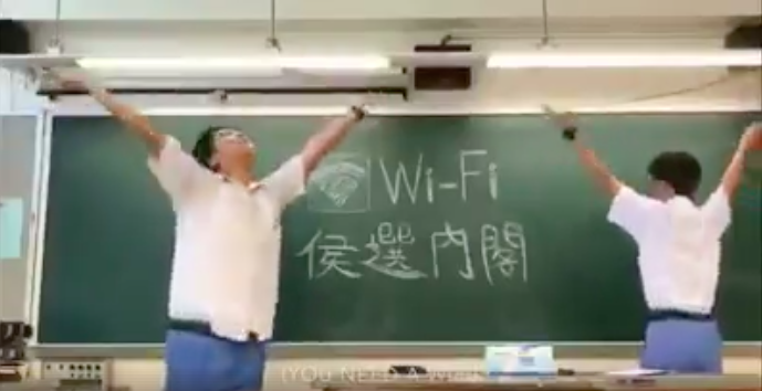 Students are filmed spinning in classrooms in a campaign rap music video for a student council election. Photo via Facebook.