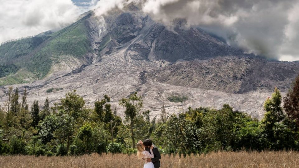 One of the many amazing wedding photos taken by Malaysian photographer Keow Wee Loong  of himself and his fiance in different countries, this one in front of Indonesia’s Mount Sinabung. Photo: Keow Wee Loong 