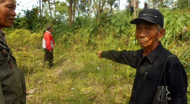 A witness to the mass killings of 1965 pointing to the location of mass graves, witnessed by the Chairman of YPKP’65, Bedjo Untung. Photo: Humas Yayasan Penelitian Korban Pembunuhan 1965-66