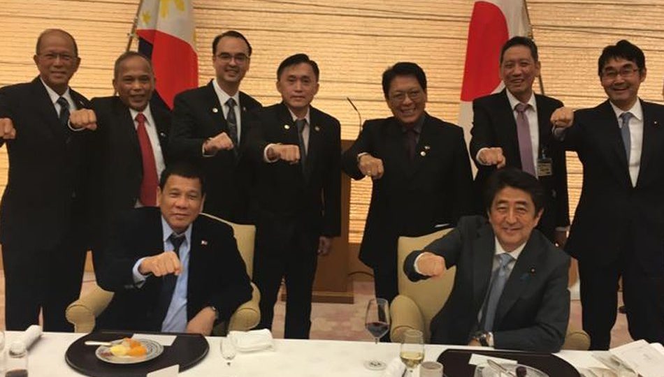 President Rodrigo Duterte with Japanese Prime Minister Shinzo Abe raise their fists — Duterte’s signature pose during Duterte’s visit to Tokyo on October 2016. PHOTO: Facebook/Christopher Bong Go