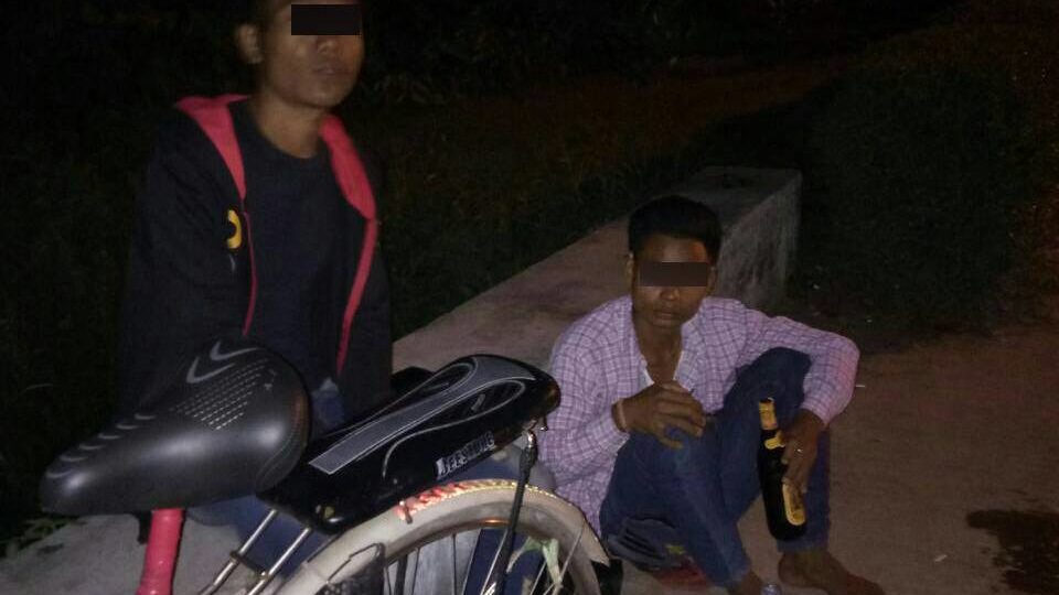 Two guys busted for public drinking. Photo: Facebook / Yangon Police