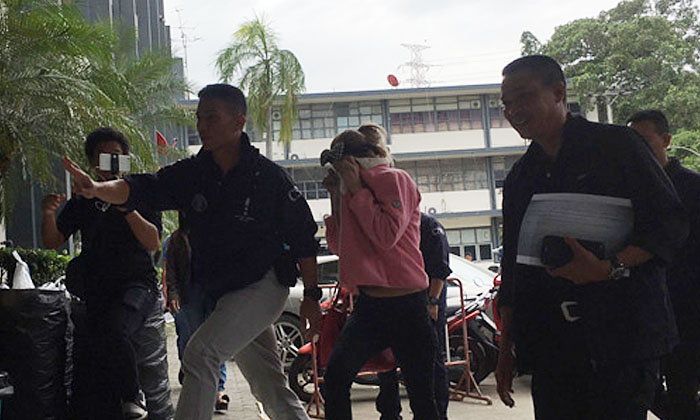 Krisana being taken in for questioning. Photo: Sanook.