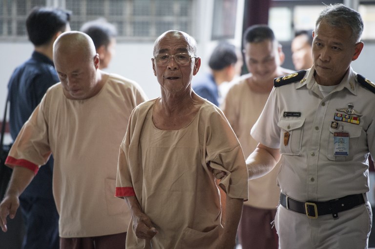 Laota Seanlee (center), a controversial guerilla fighter long accused of playing a key role in the Golden Triangle drugs trade, is escorted into a Criminal Court in Bangkok on December 13, 2017. Photo: Lillian Suwanrumpha/ AFP