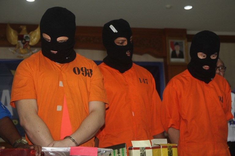 Drugs suspects Australian IER (L,) American KSL (C) and Malaysian CHJ (R) are displayed by officials during a press conference at a customs office in Denpasar, on the island of Bali on December 19, 2017. 
An Australian man is one of three foreigners facing severe penalties for drug trafficking after he was caught attempting to smuggle crystal methamphetamine into the resort island of Bali, an Indonesian official said on December 19. / AFP PHOTO / JOAN ARI