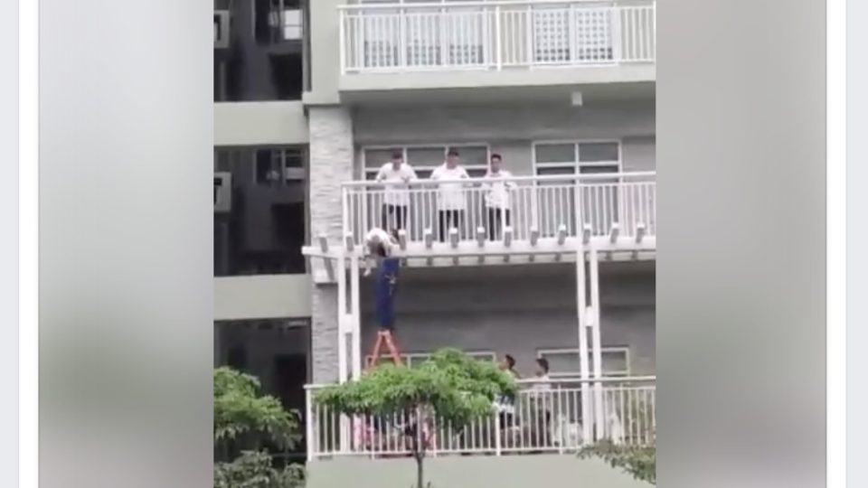 Maintenance and security officers of Two Serendra Condominium in BGC try to retrieve the child’s body. Screengrab from Reinna Athena Grace Obligar’s Facebook video
