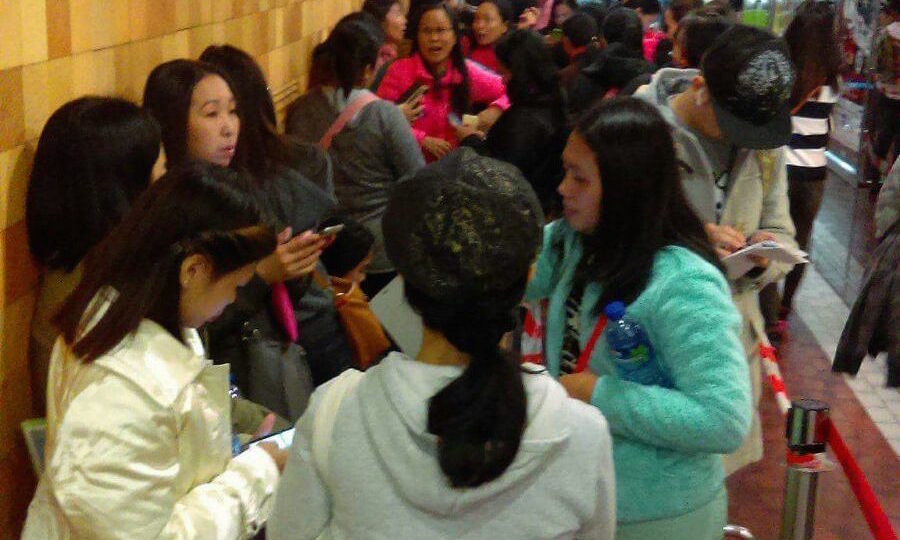 Domestic helpers line up at World-Wide House on Thursday in a bid to get answers from Peya travel agency. Picture: Merly Bunda