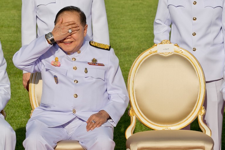 In this photograph taken on Dec. 4, 2017, Thailand’s junta number two Prawit Wongsuwan covers his eyes, displaying a watch he is wearing, during a photo call with other members of a new cabinet in Bangkok. PHOTO: Krit Phromsakla Na Sakolnakorn/ AFP