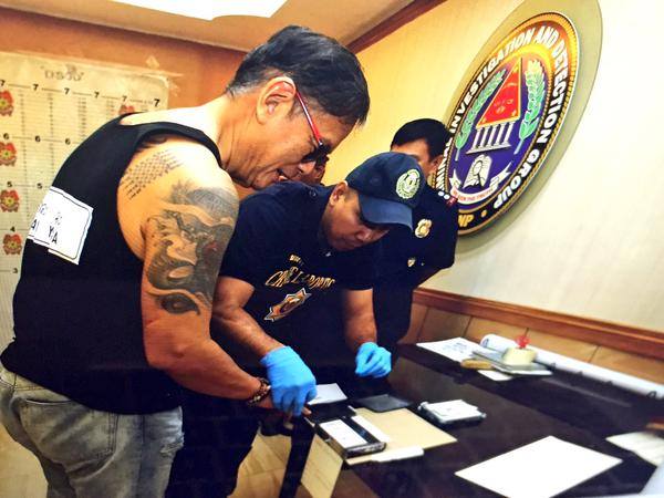 One of the Reyes brothers gets fingerprinted after his arrest in 2015. PHOTO: Facebook/Jusitce for Dr. Gerry Ortega