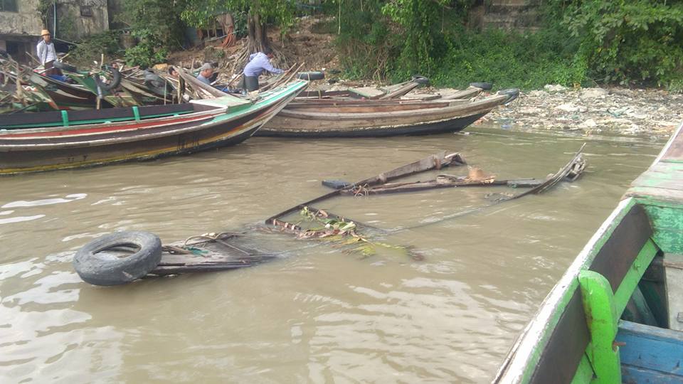 small wooden motorboat sunk by the stray oil tanker