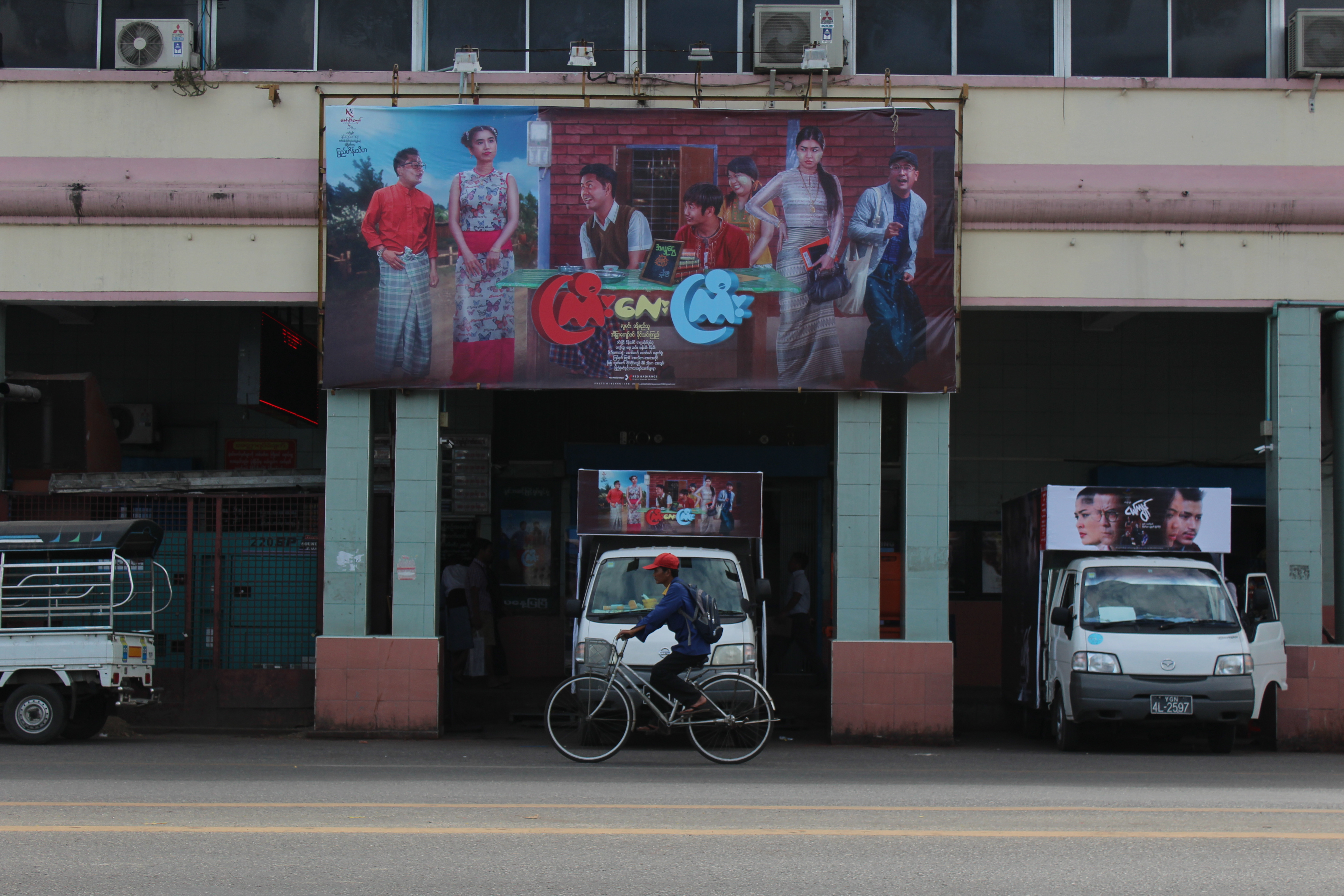 A man cycles past a cinema where “Kyi Lay Kyi” is showing on Jan. 25, 2018. The film is about two men’s “hilarious” quest to rape two women. Photo: Jacob Goldberg