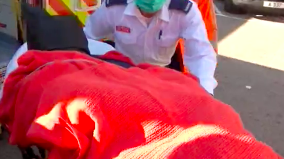 The suspect, a 42-year-old surnamed Kim, strapped to a hospital gurney yelling as he’s wheeled from the ambulance in January. Screengrab via Apple Daily video.