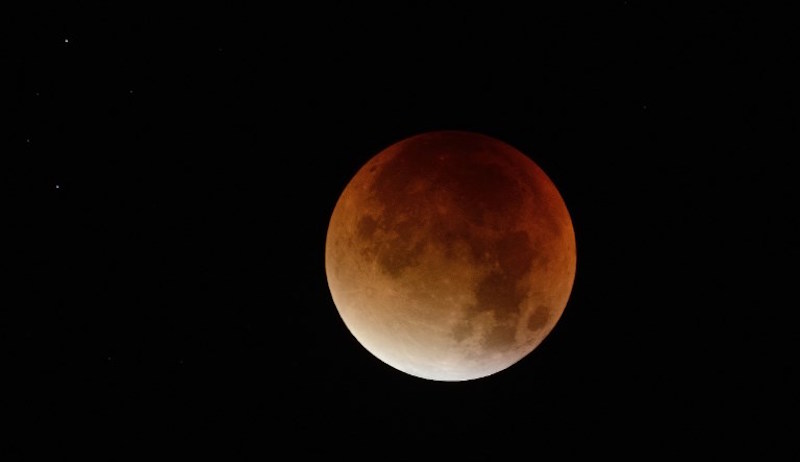 A swollen “supermoon” bathed in the blood-red light of a total eclipse is seen in Nantes, western France, early on September 28, 2015. Photo: Jean-Sebastien Evrard/AFP 