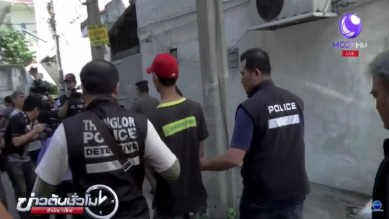 The suspect being led to the crime reenactment. Photos: Thai News Agency